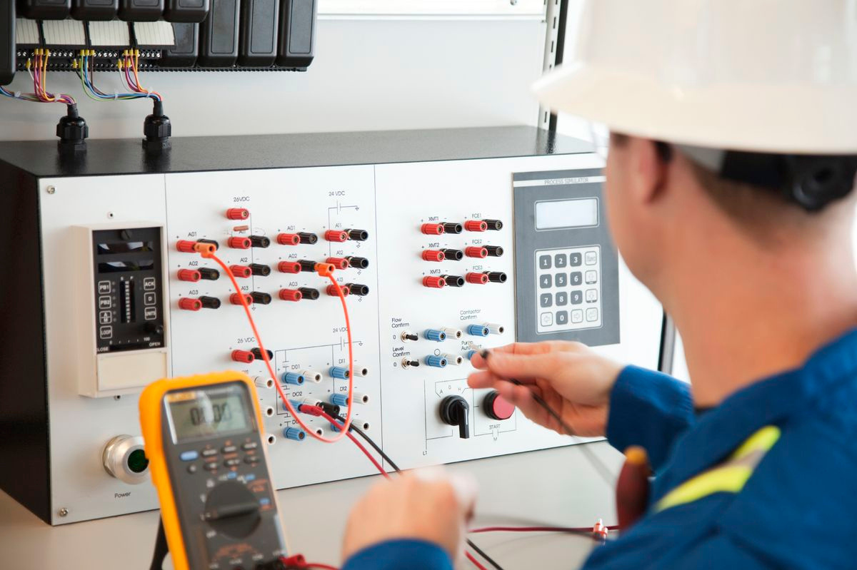 Electrical engineer testing control equipment